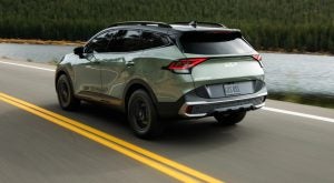 The 2023 Kia Sportage driving down the road. 