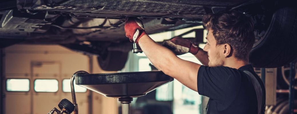 Technician performing an oil change service