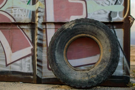 Old tire leaning against wall