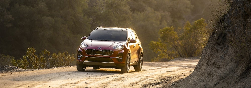 Red 2020 Kia Sportage Driving Around Curve