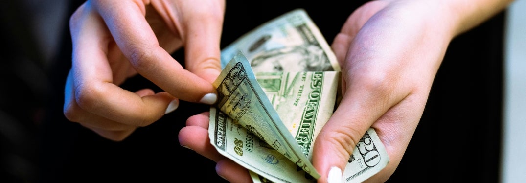 Woman Counting Dollar Bills