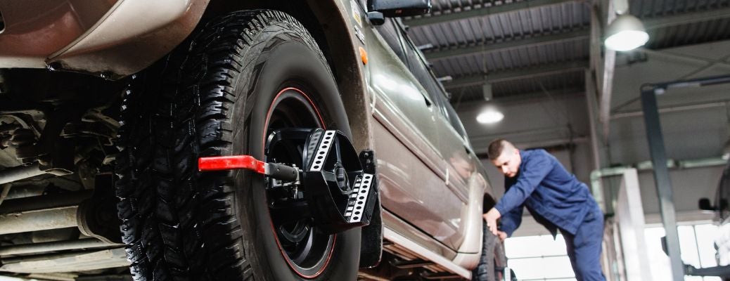 a car undergoing wheel alignment