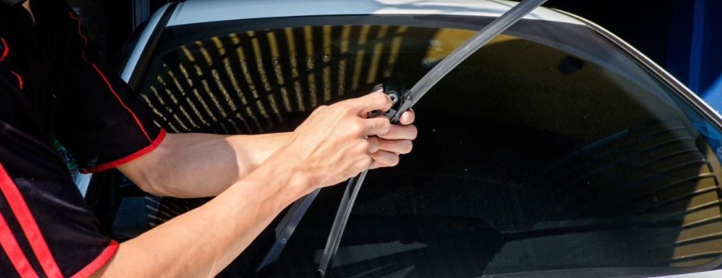 Technician adjusting windshield wiper