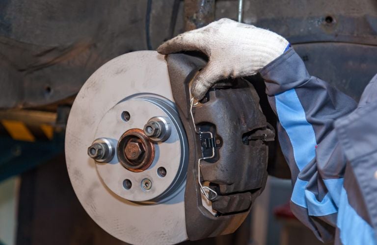 technician fixing brake pad