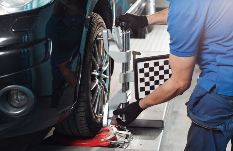 A serviceman checking Wheel Alignment