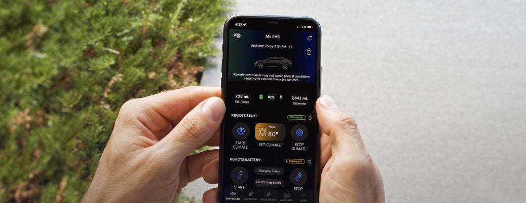 Hands using the Kia Connect app