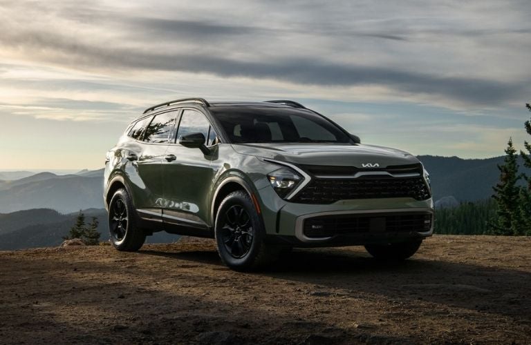 A 2023 Kia Sportage on a muddy terrain