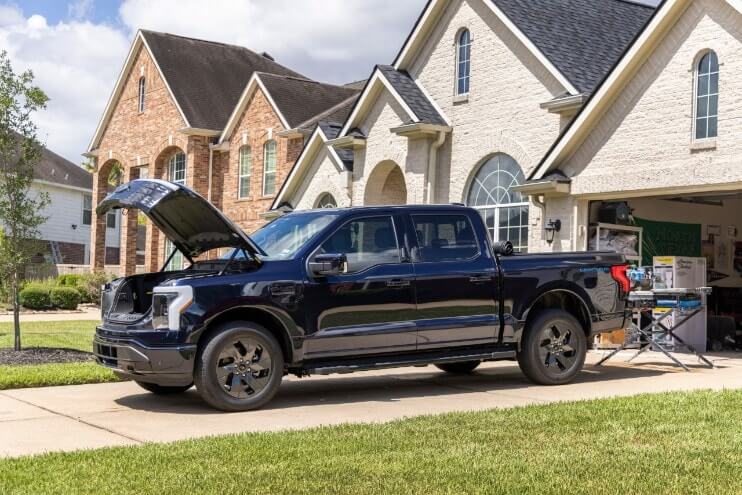 Ford Lightning parked at house, showing off features.