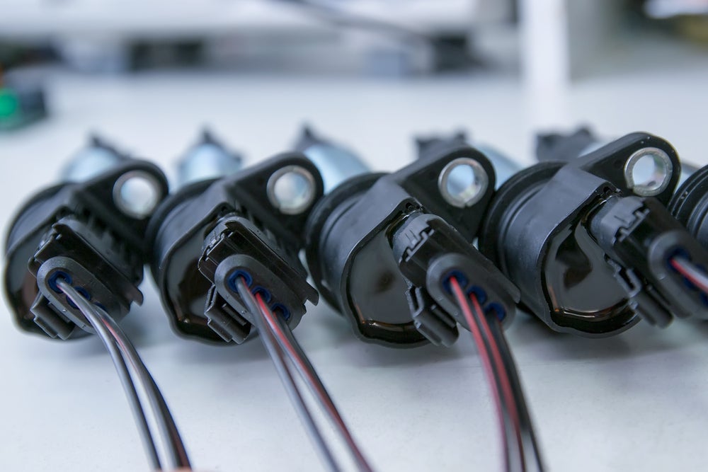 Row,Of,Ignition,Coils,On,A,White,Background