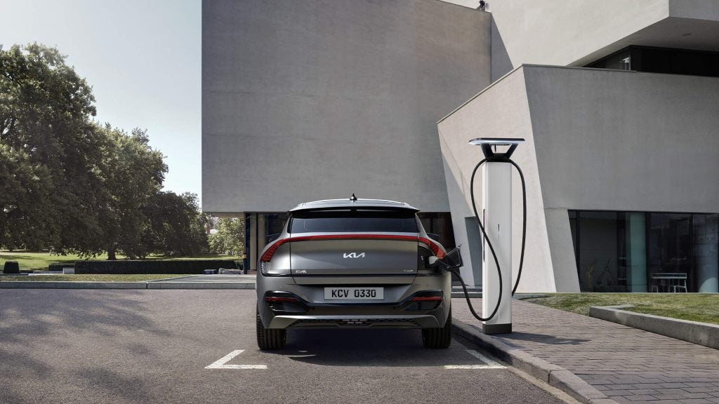 Kia electric vehicle parked at a public EV charging station