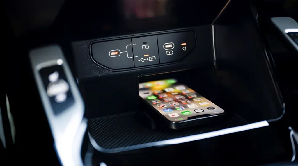 2026 Kia Sorento wireless phone charging area with smartphone in the center console