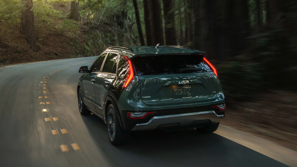 2026 Kia Niro Hybrid driving on a forest road