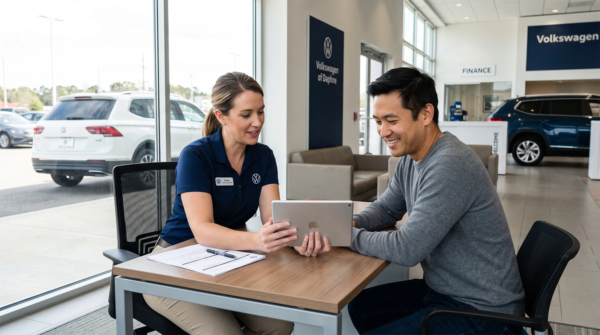 Volkswagen finance specialist reviewing auto loan options with a customer at Volkswagen of Daphne.