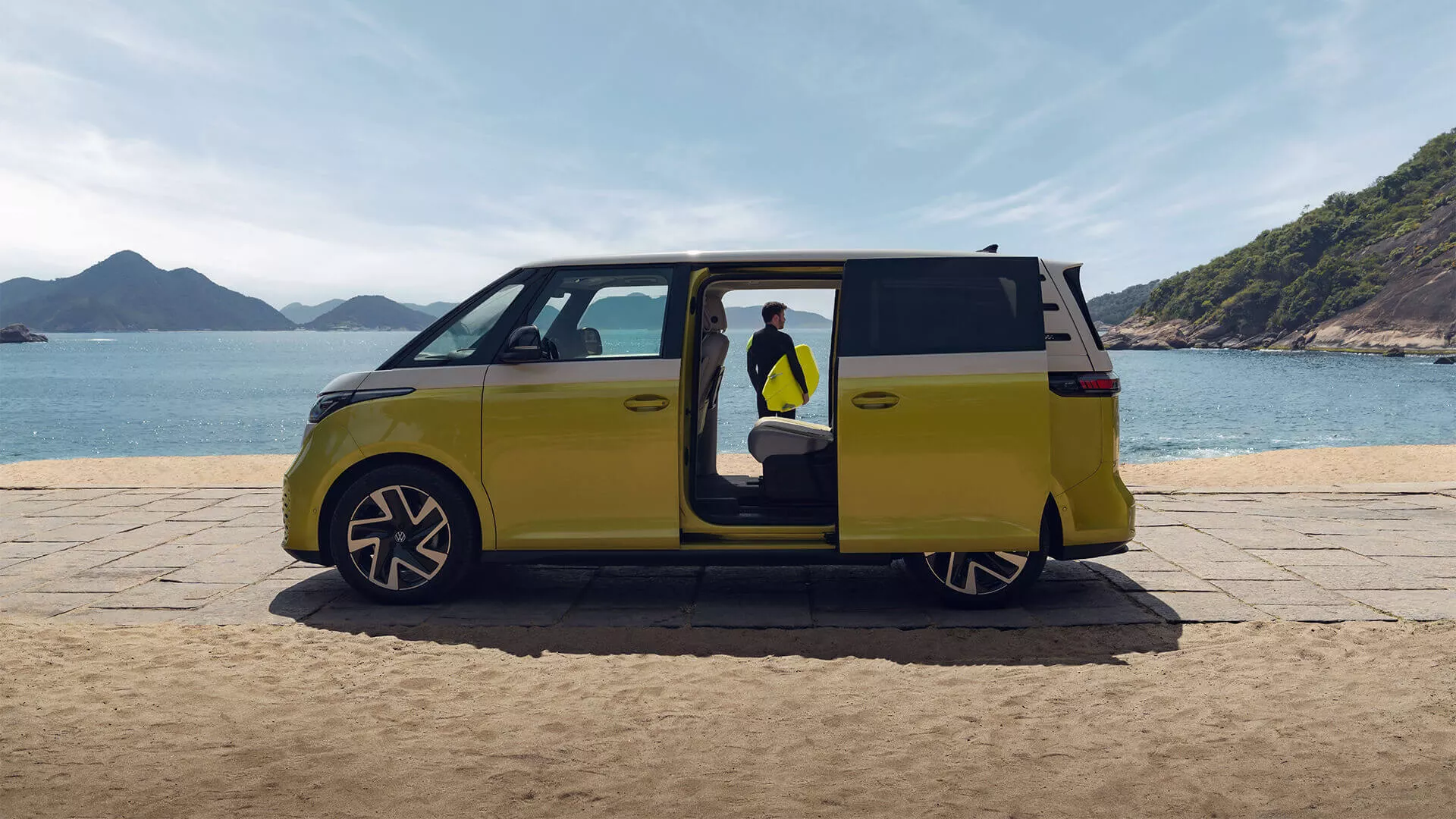 Volkswagen ID. Buzz parked by the beach with sliding door open for a Gulf Coast road trip
