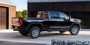 Right angle rear view of a black 2024 Chevy Silverado HD parked in a driveway | Vancouver, WA
