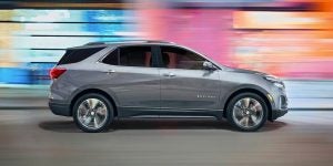Silver 2024 Chevy Equinox left side profile with a blurred colorful background | Vancouver, WA
