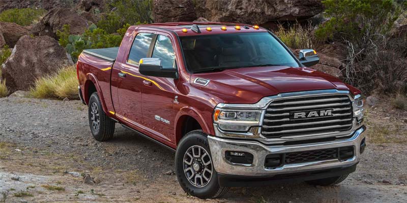 A red RAM 2500 in a wilderness backdrop.