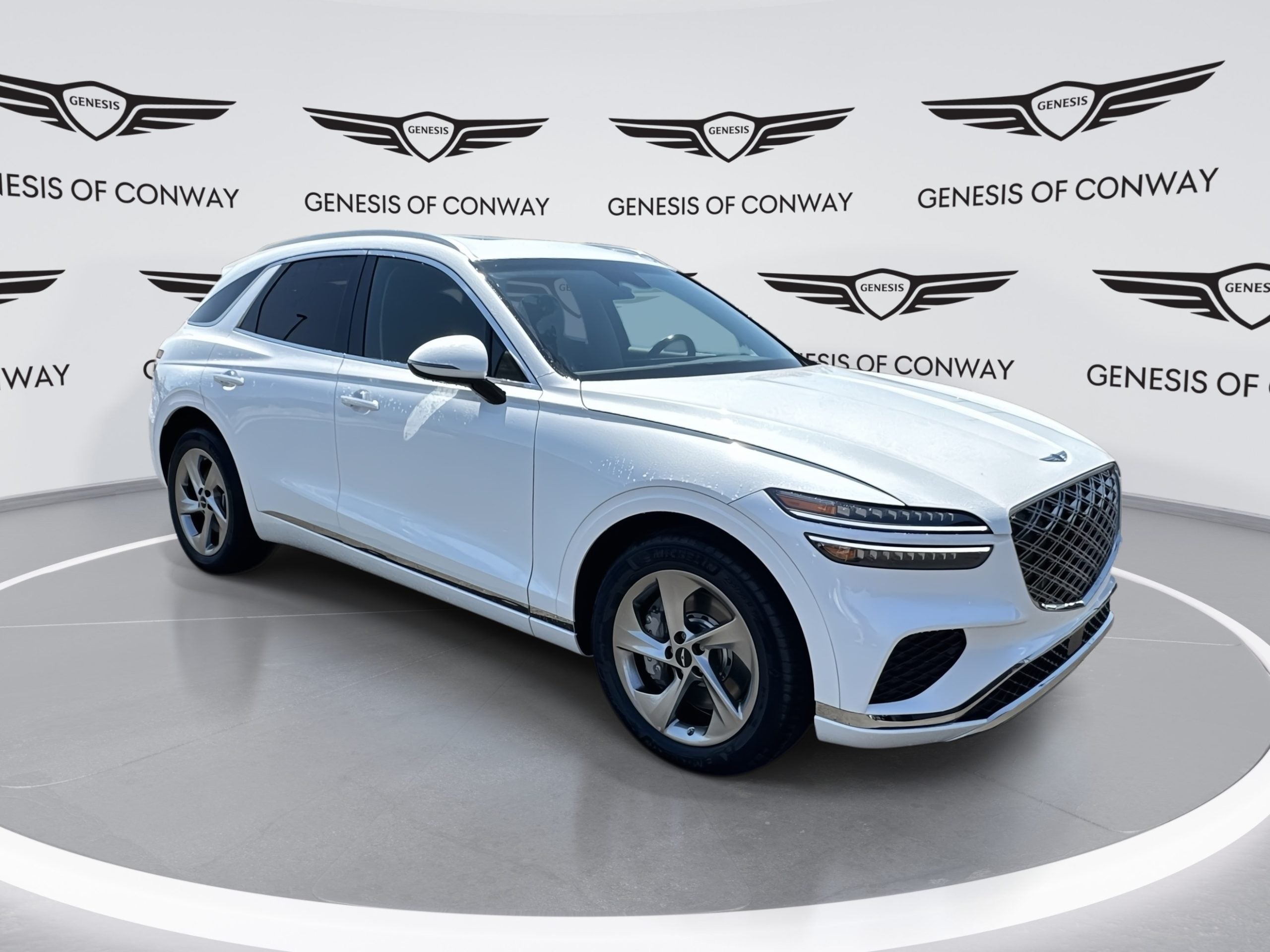 2026 Genesis GV70 luxury SUV in white parked at Genesis of Conway showroom