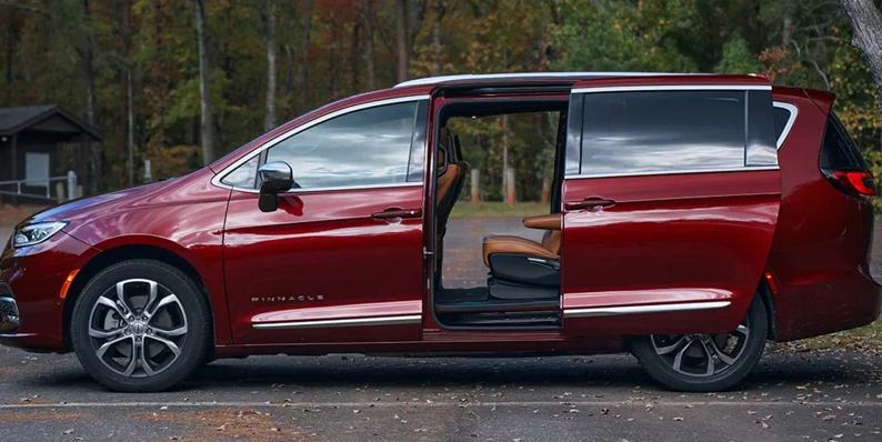 A photo of a 2026 Chrysler Pacifica parked in a parking lot with both side doors open.