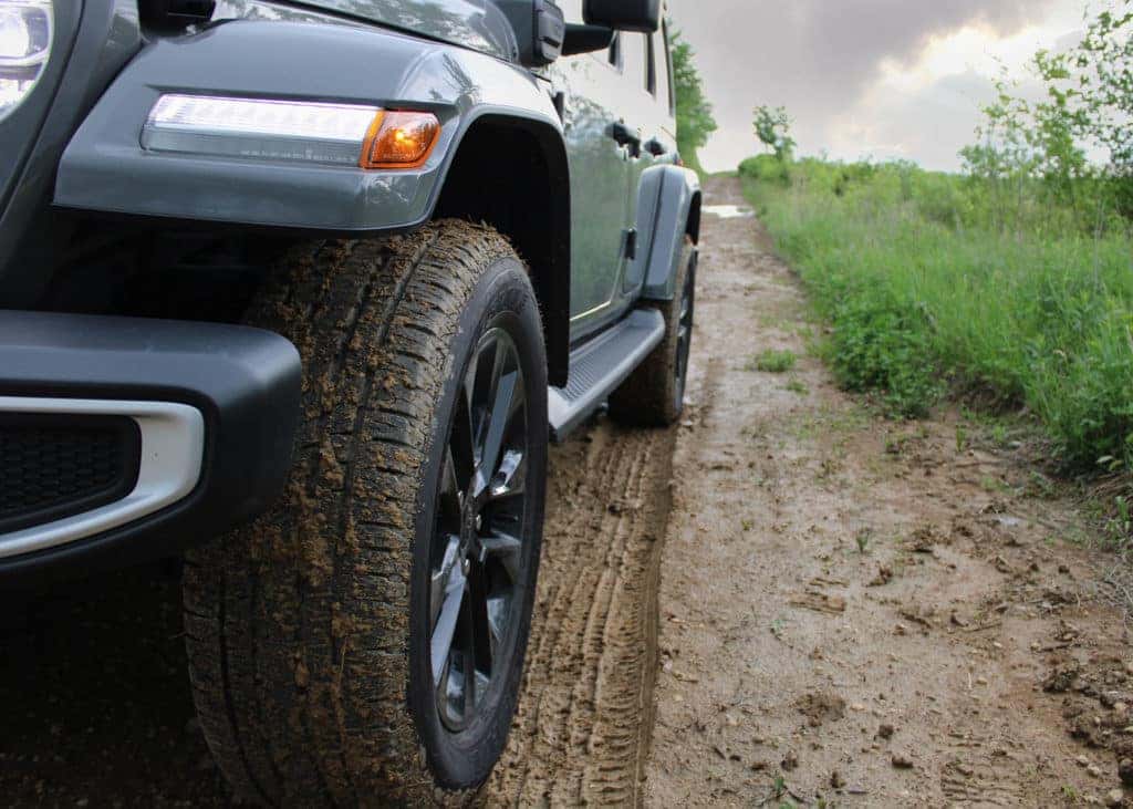 Close up on muddy tire on a Wrangler on a dirt road