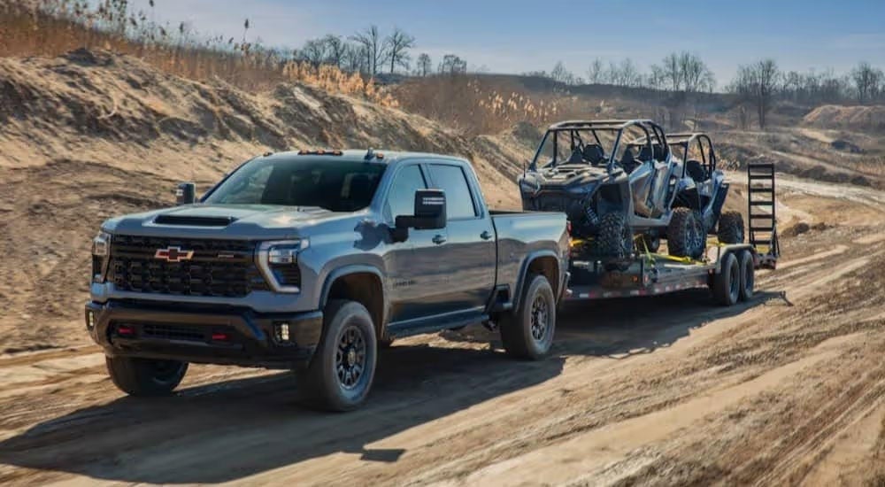 Silverado HD pulling a trailer with atvs on it. 