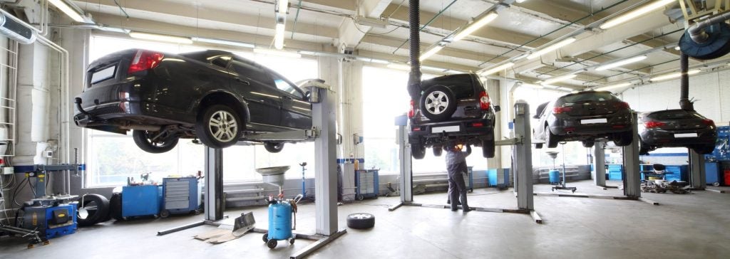 Jeep service center with multiple vehicles on lifts undergoing maintenance and inspection, highlighting professional auto repair, certified technicians, and multi-point inspection services.