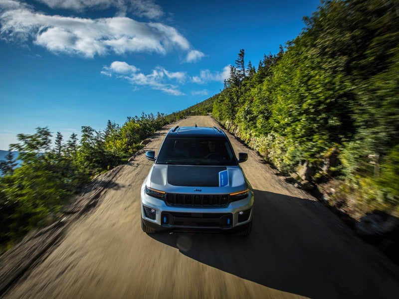 Hybrid vehicle driving down a road in Mason MI