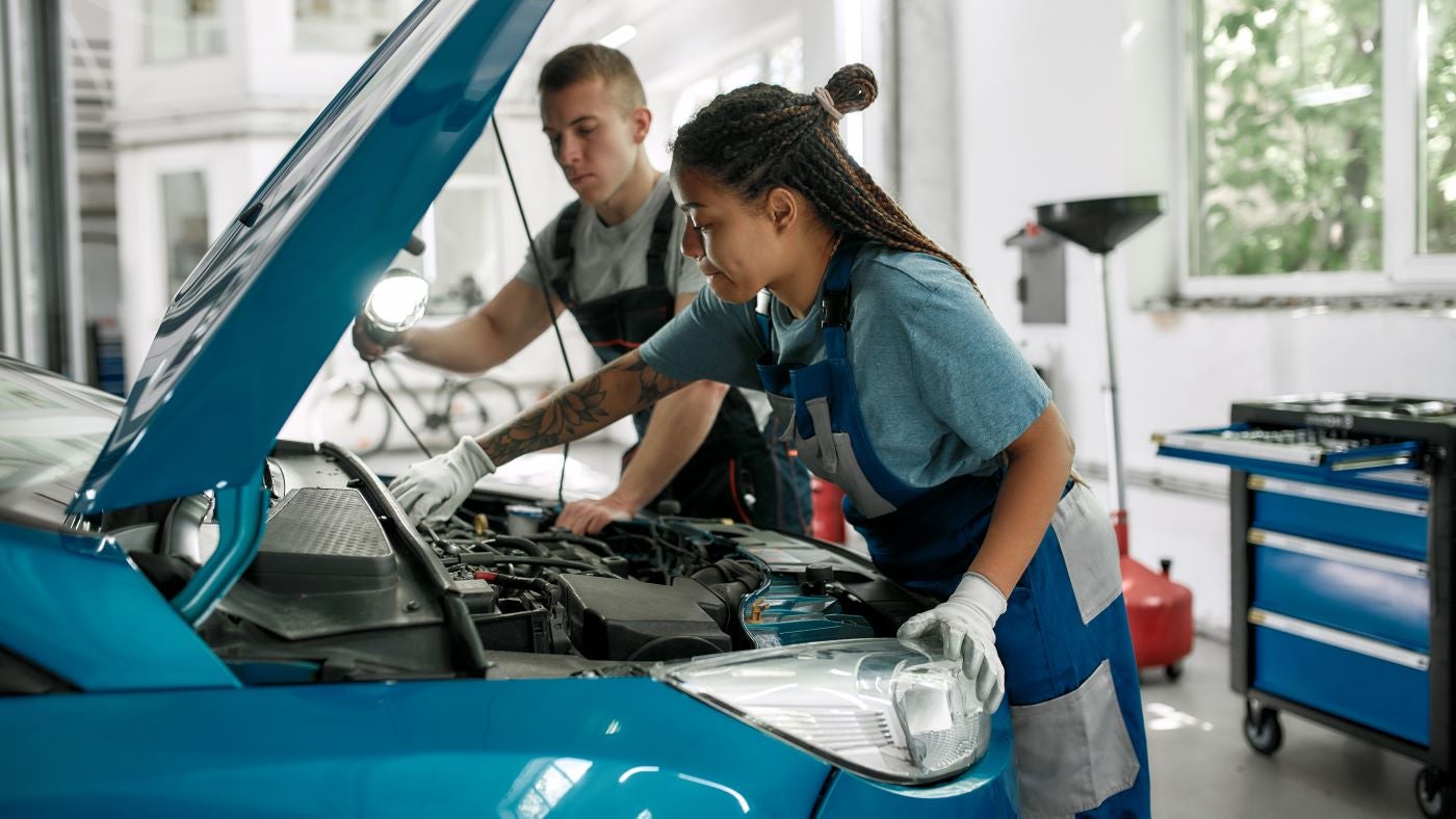 Customer signing a loan for a hybrid vehicle in Michigan