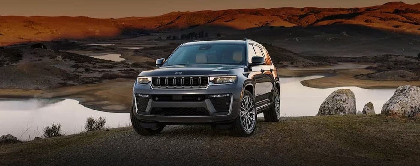 A gray 2026 Jeep Grand Cherokee parked near water.