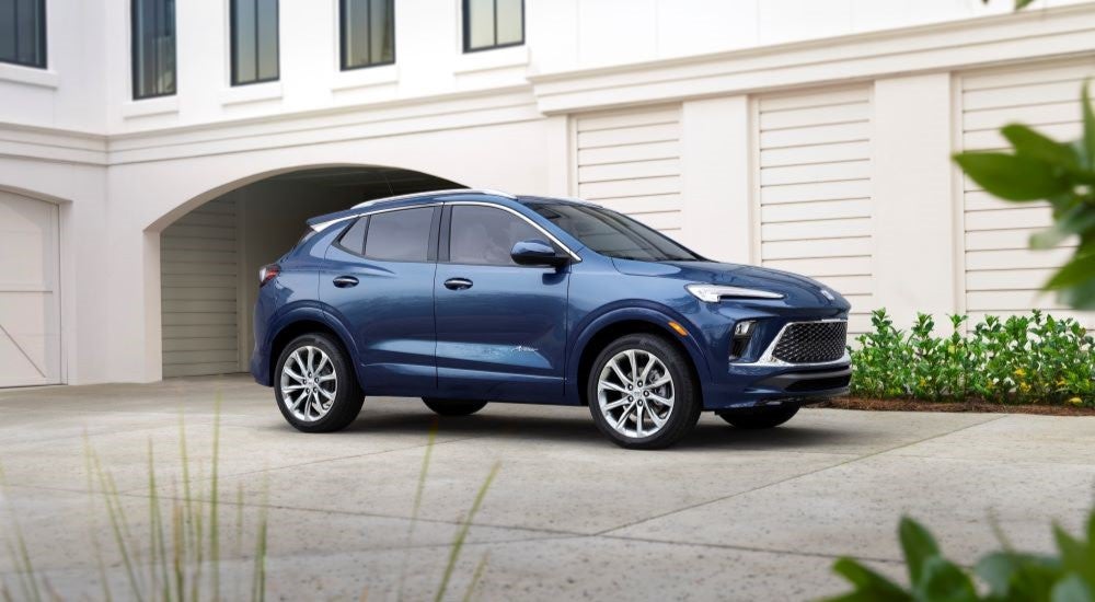 A blue 2024 Buick Encore GX Avenir is shown from a side angle.