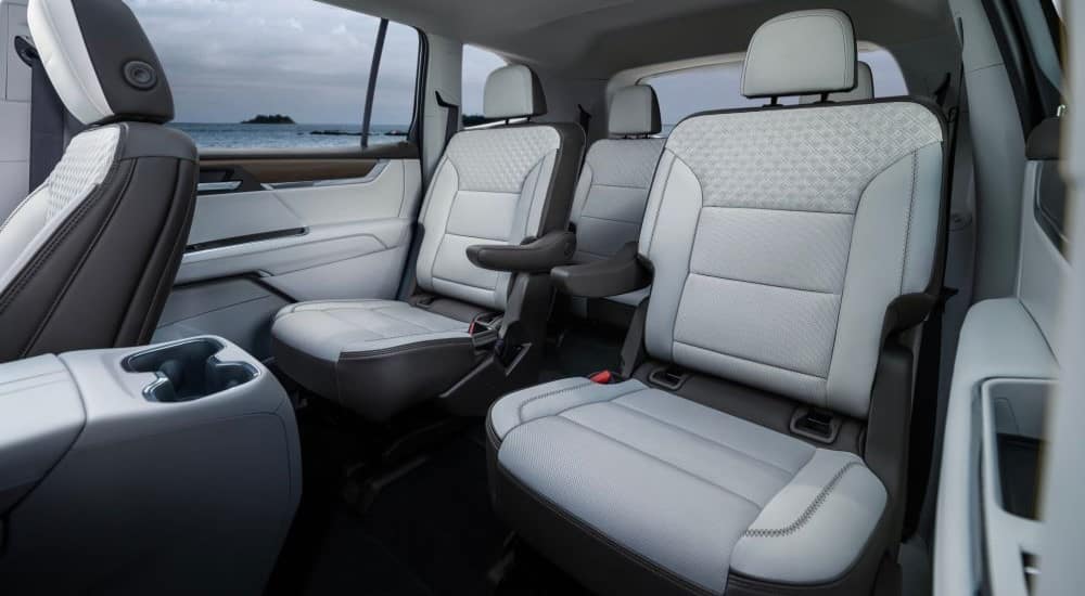 The rear white seats are shown in a 2024 GMC Acadia Denali.