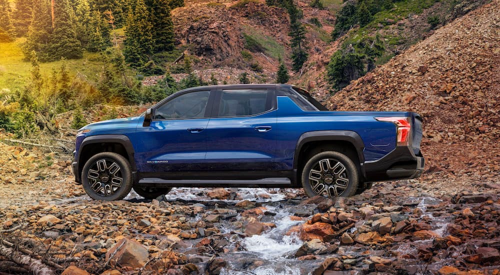 A blue 2025 Chevy Silverado EV RST is shown from the side.