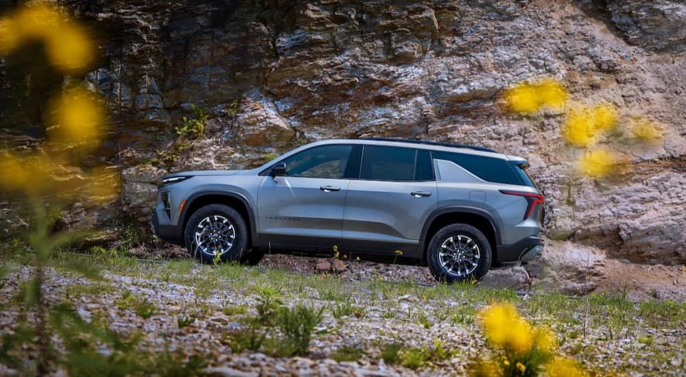 A grey 2024 Chevy Traverse Z71 is shown driving.