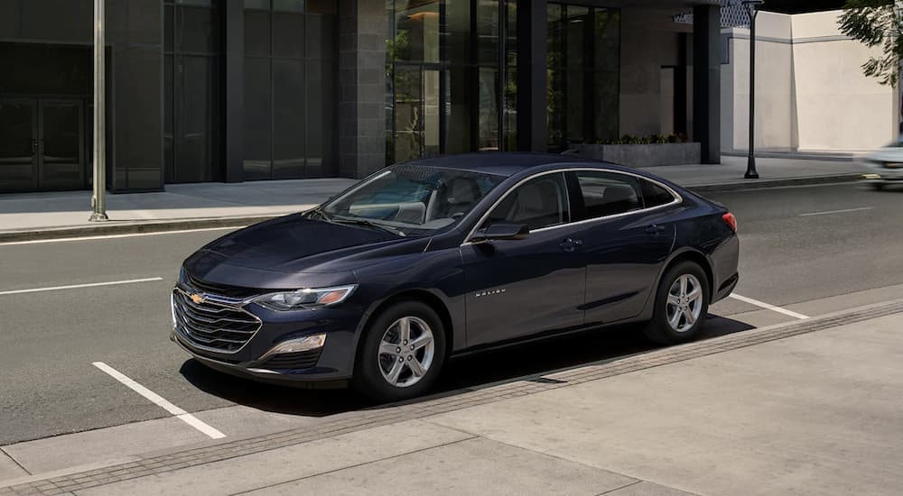 A blue 2023 Chevy Malibu Parked in the city.