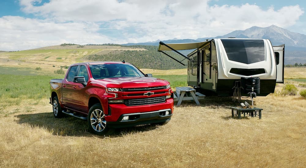 Red 2022 Chevy Silverado 1500 parked at a campsite
