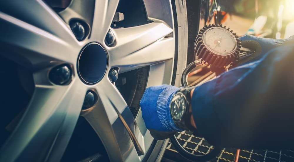 A technician checking tire pressure.
