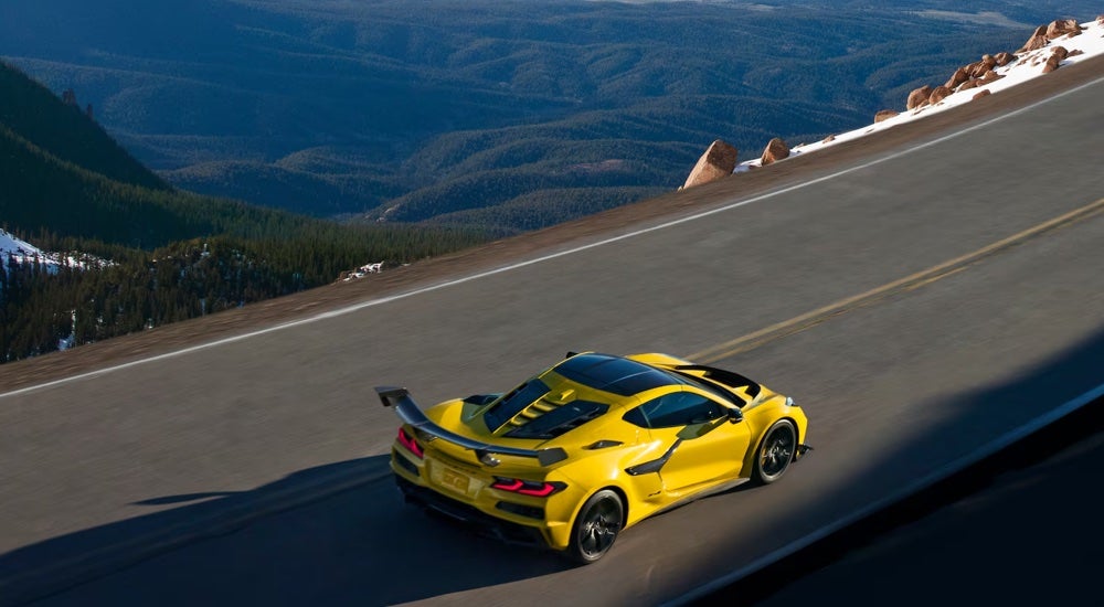 Overhead view of a yellow 2025 Chevy Corvette ZR1 driving on a mountain road.