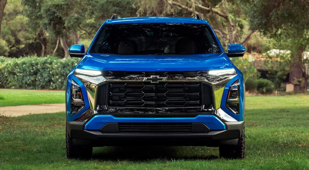 Front of a blue 2027 Chevy Equinox parked off-road.