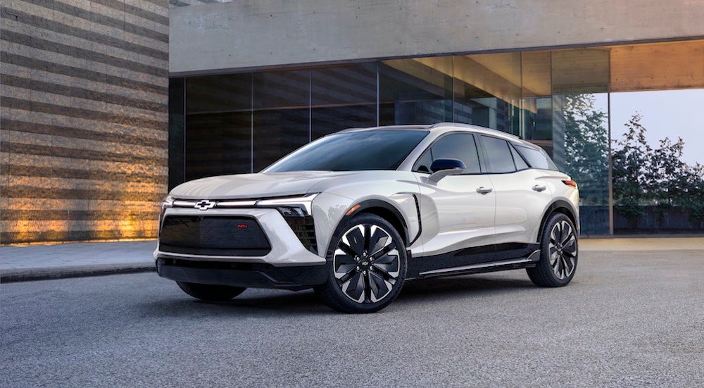A white 2024 Chevy Blazer EV parked outside a building and angled left.