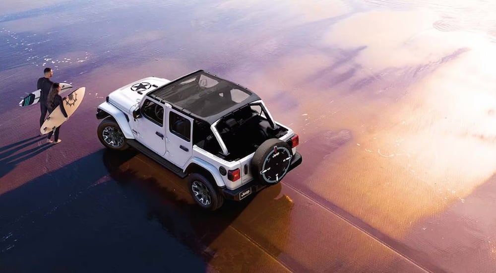 High view of a white 2026 Jeep Wrangler driving off-road.