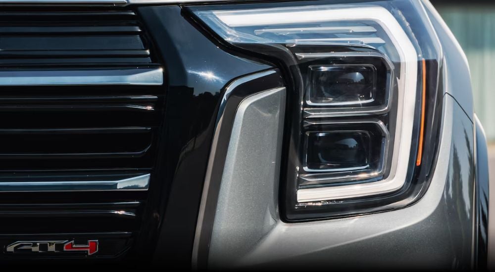 The front end of a grey 2026 GMC Terrain AT4 is shown in close-up.