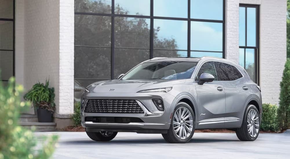A silver 2024 Buick Envision Avenir parked on a driveway.