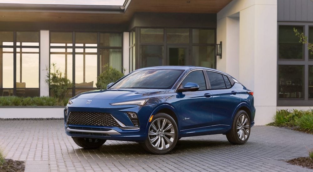 A blue 2024 Buick Envista parked outside a building after visiting a Buick dealer near Fenton.