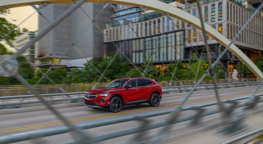 A red 2025 Buick Envision is shown from the side after leaving a Buick dealer near Wixom.