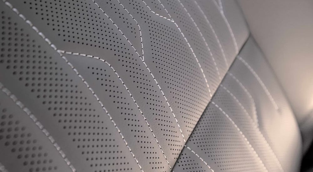 A close up shows stitching on the grey leather seat in a 2025 Buick Envista.