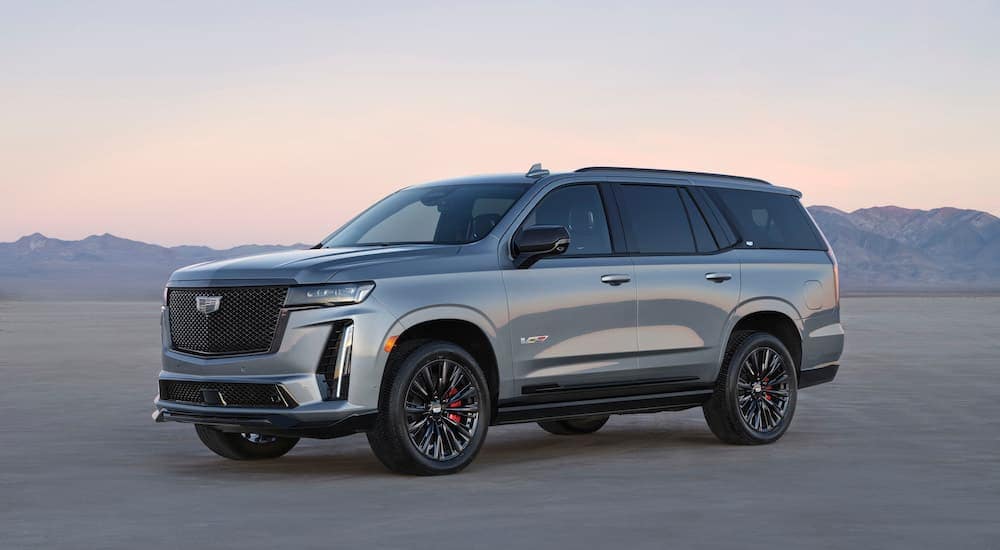 A silver 2024 Cadillac Escalade V is shown from the side.