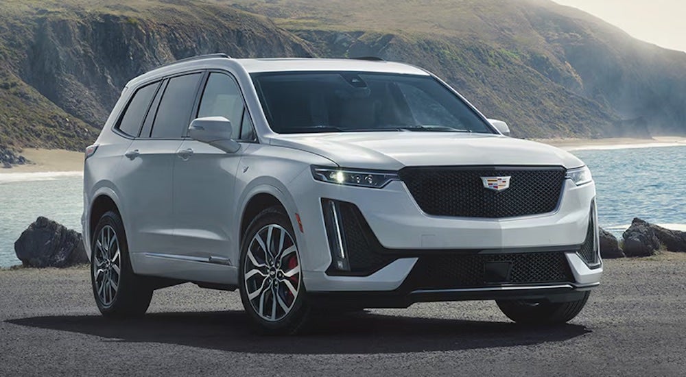 A white 2024 Cadillac XT6 is shown from the front at an angle.