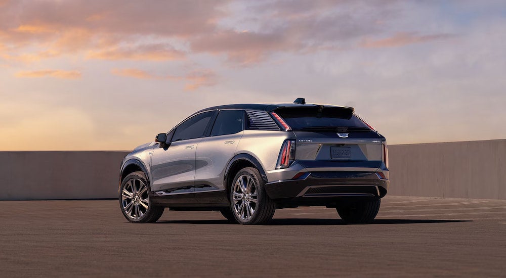 Rear angle view of a silver 2025 Cadillac OPTIQ parked on a lot.