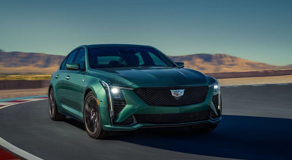 A green 2026 Cadillac CT5-V Blackwing shown driving on a race track.