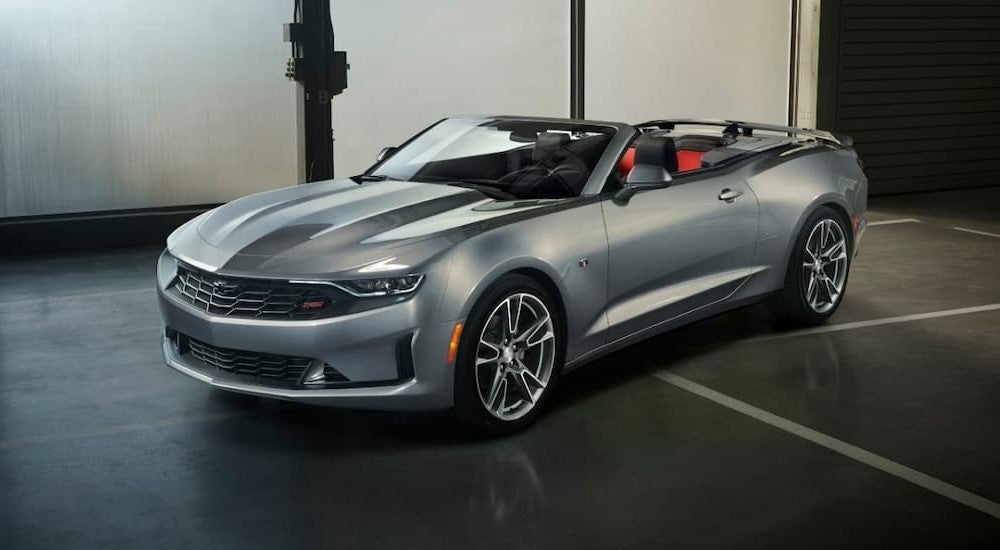 A silver 2019 Chevy Camaro parked in a showroom.